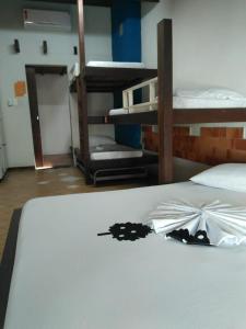 a bed in a room with two bunk beds at Laranjeiras Hostel in Salvador