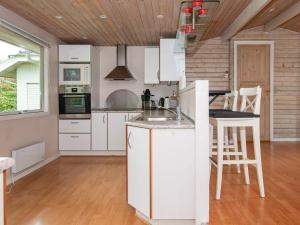 una cucina con armadi bianchi e soffitto in legno di 6 person holiday home in B rkop a Egeskov