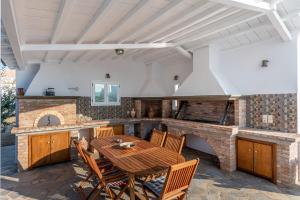 a kitchen with a wooden table and a stove at Stargaze Villas in Panormos Skopelos