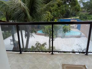 a view of a swimming pool from a balcony at Pousada Arco-Íris in Guarujá