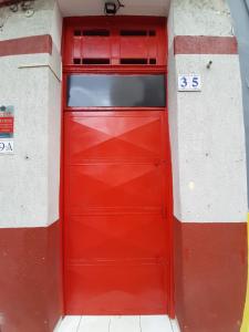 a red garage door in a building with at Santa Ceciliers in São Paulo