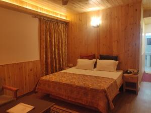 Postel nebo postele na pokoji v ubytování Vatsalyam Home Stay