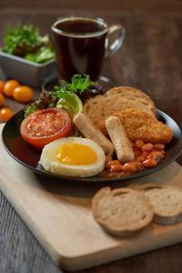 a plate of breakfast food with eggs sausage and bread at Aerotel Kuala Lumpur (Airport Hotel) - Gateway@klia2 in Sepang