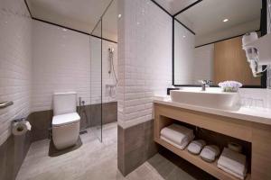 a bathroom with a sink and a glass shower at Aerotel Kuala Lumpur (Airport Hotel) - Gateway@klia2 in Sepang