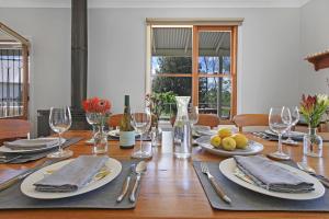 a dining room table with plates and wine glasses at Country House Retreat in Nungurner