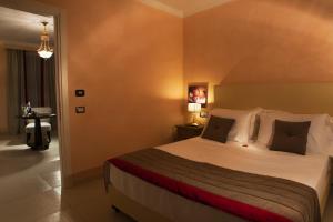 Postel nebo postele na pokoji v ubytování L' Araba Fenice Hotel & Resort