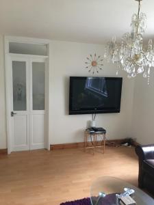 a living room with a flat screen tv on the wall at Pendleton in Peterborough