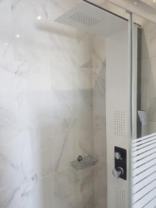a shower with a glass door in a bathroom at studios FLORA in naoussa paros in Naousa +45 photos
