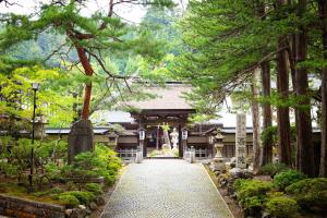 a path leading to a shrine in a garden at Koyasan Shukubo Saizenin in Koyasan