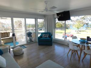 a living room with a couch and a table at Secret at Huskisson in Huskisson