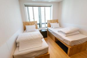 Ein Bett oder Betten in einem Zimmer der Unterkunft Step Inn Myeongdong 1