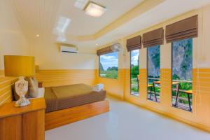 a bedroom with a bed and windows with a view at Railay Hilltop in Railay Beach +64 photos