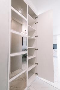 a walk in closet with white shelves at Royal Tower VIP Smart Apartments 2 in Kyiv