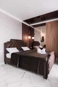 a bedroom with a large bed with two white pillows at Royal Tower VIP Smart Apartments 2 in Kyiv