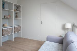 sala de estar con sofá y estanterías en LE DUPLEX - Appartement familial cosy, en Saint-Nazaire