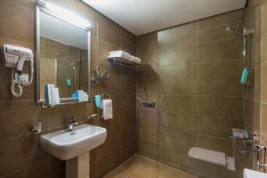 a bathroom with a sink, toilet and shower at Boudl Al-Jubail - Danah Al-Jubail Suites in Al Jubail