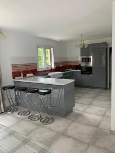 a kitchen with a counter and stools in it at Chez Mado in Deauville