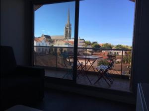 a view of a balcony with a view of a church at Appartement à Arcachon à 3 min à pied de la plage in Arcachon