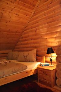 ein Schlafzimmer mit einem Bett in einem Blockhaus in der Unterkunft Chalet mit Schlossblick Wernigerode, Chalet 2 in Wernigerode