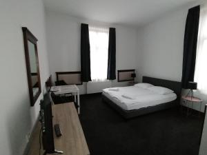 a hotel room with a bed and a window at Villa Grudziądz in Grudziądz