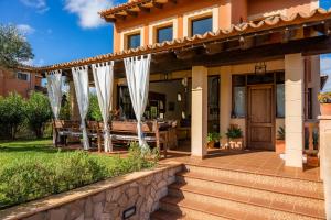 a patio of a home with white curtains at Estrella in Son Serra de Marina