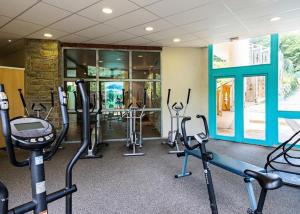 a gym with several treadmills and exercise bikes at Appartement F2 au domaine des 100 lacs - piscine - sauna - hammam in Cauterets