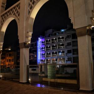 a building with blue lights on it at night at Hotel Le Mus&eacute;e in Rabat