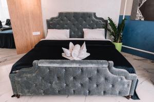 a bedroom with a large bed with a flower on it at Royal Tower VIP Smart Apartments 3 in Kyiv