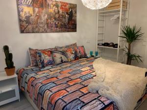 1 dormitorio con 1 cama con un edredón colorido en Enjoy Ávila -LA CATEDRAL, en Ávila