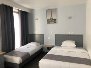 Postel nebo postele na pokoji v ubytování Hôtel Clauzel Paris