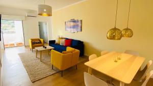a living room with a couch and a table and chairs at Rooftop by Check-in Portugal in Albufeira