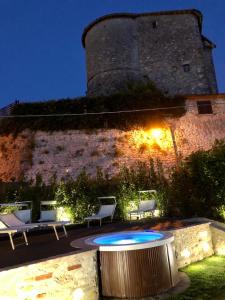 a building with a table and chairs and a castle at Arenarius Home Resort & SPA in Torricella in Sabina
