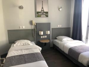 Postel nebo postele na pokoji v ubytování Hôtel Clauzel Paris