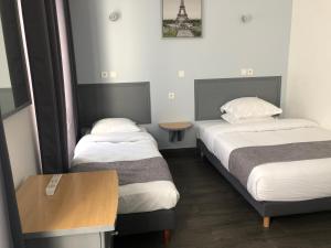Postel nebo postele na pokoji v ubytování Hôtel Clauzel Paris