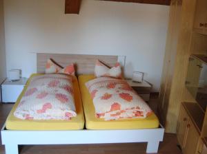 a bed with two pillows on it in a room at Alt Weeze in Weeze