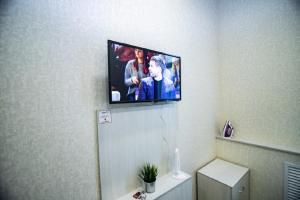 a flat screen tv on the wall of a bathroom at Студия ЦЕНТР города, Красноармейский 96а in Barnaul