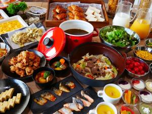 una tavola con molti tipi di cibo diversi di Hotel Wing International Sapporo Susukino a Sapporo