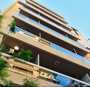 a tall building with windows and plants on it at Divan Hotel Apartments in Beirut
