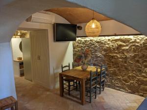 a dining room with a wooden table and chairs at Can Puig CAVE in La Pera