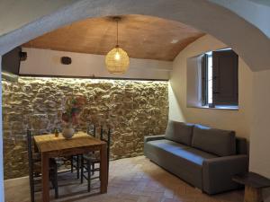 a living room with a table and a couch at Can Puig CAVE in La Pera