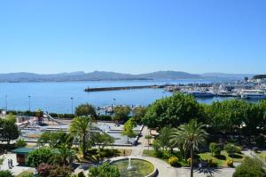 a view of a large body of water with boats at Hotel Airiños 3* in Cangas de Morrazo