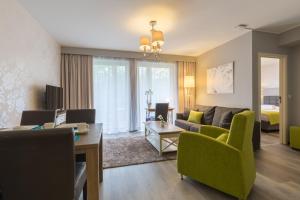 a living room with a couch and a table at Thon Hotel Residence Parnasse Aparthotel in Brussels