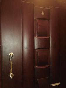 a wooden door with a handle and a book shelf at Studio Apartment at Tiba Star in Hurghada