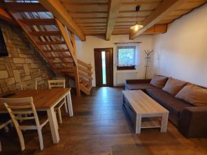 a living room with a couch and a table at Apartmány Švec in Terchová