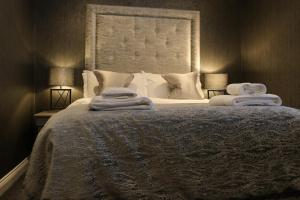 a bedroom with a large bed with towels on it at The Bold Hotel; BW Signature Collection in Southport