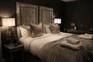 a bedroom with a large bed with two pillows on it at The Bold Hotel; BW Signature Collection in Southport