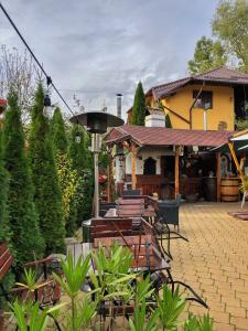 a house with a patio in front of it at Pensiunea PORTAS RESORT in Slănic