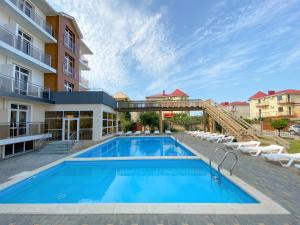 a swimming pool in front of a building at Ambra Resort Hotel All inclusive in Anapa