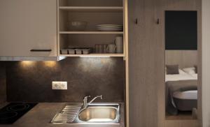 a kitchen with a sink and a counter top at Hotel Das Essigmanngut in Anif +79 photos
