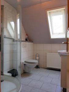 a bathroom with a toilet and a sink and a window at Haus mit Seele im Nahetal in Weinsheim +47 photos